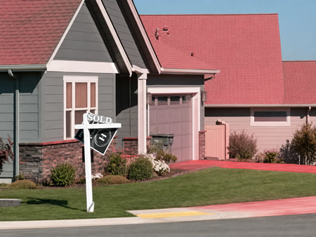 Pink fire retardant residue covering the exterior of a Spokane-area home